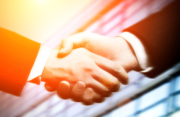 Close-up of adult industry professionals shaking hands