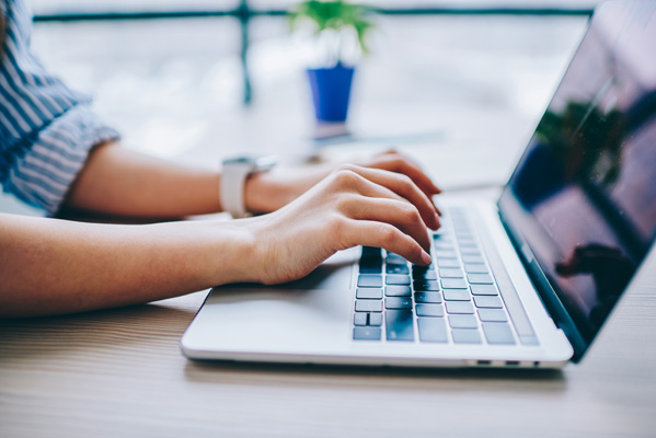 Woman searching for paysites on laptop