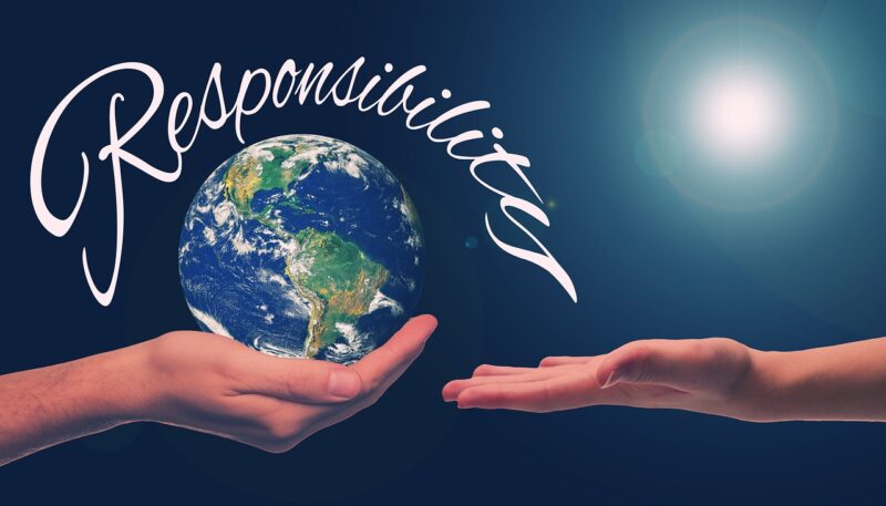Hands holding a globe with the word responsibility
